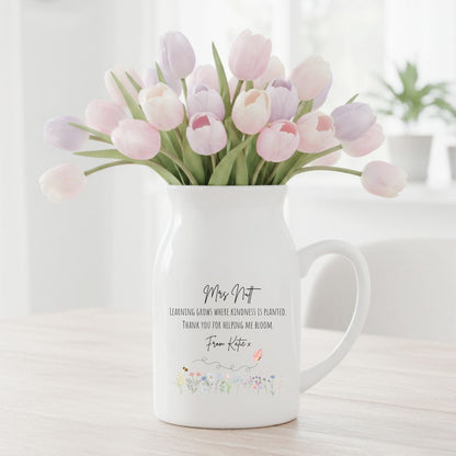 Personalised white ceramic vase with teacher and pupil name, filled with pink and purple tulips